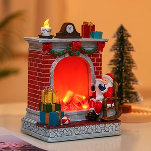 Christmas resin fireplace scene with Santa sitting on chair and warm glowing LED lights