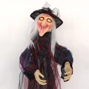 Close-up of Halloween witch prop with glowing red eyes and tattered robe detail
