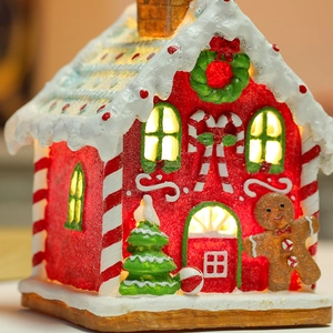Luminous Christmas gingerbread house decoration with warm LED lights and resin craftsmanship