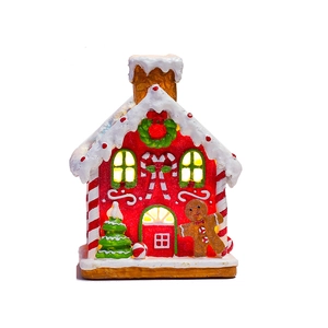 Illuminated resin gingerbread house decor with LEDs, snow roof, and festive figurines