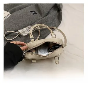 Top-down detail of beige Boston bag interior showing capacity for cosmetics and daily items