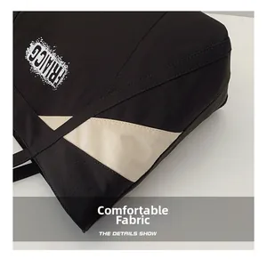Detail view of the contrast color canvas tote with RIACG print and stitched fabric texture