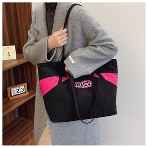 Close-up of contrast color canvas tote with double straps and graffiti logo lettering