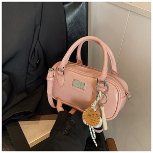 Pink bowling handbag detail with glossy leather finish and baseball-themed charm