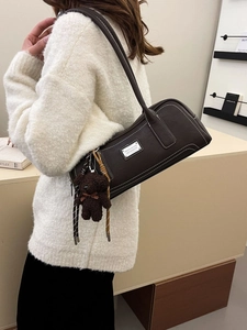 Vintage dark brown faux leather baguette bag with white stitching and bear charm