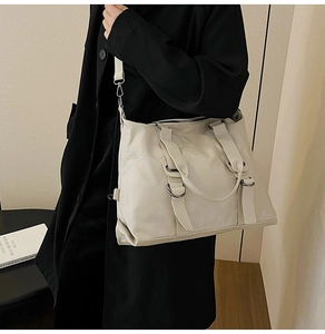 Detail of cream white PU leather tote bag showing soft texture and crossbody strap