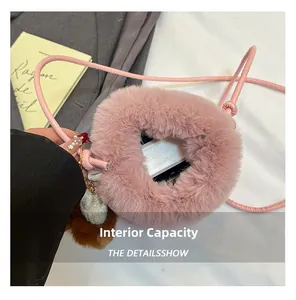 Detail view of pink plush crossbody bag showing internal capacity and soft fluffy texture