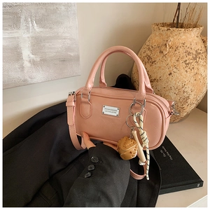 Detailed view of pink bowling bag with silver plaque on professional business attire