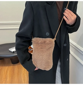 Brown faux fur crossbody bag with cute monster charm and slim shoulder strap