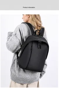 Minimalist black backpack showing wide padded ergonomic shoulder straps on model