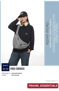 Detail view of large dark grey crossbody dumpling bag with adjustable black nylon strap