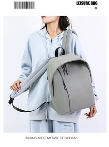 Light gray minimalist backpack with durable fabric and multi-compartment zipper design