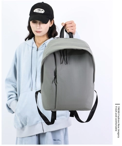 Close-up of a minimalist grey backpack featuring waterproof nylon fabric and sleek hidden pocket