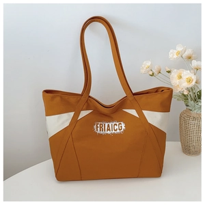Detail shot of the contrast color canvas tote bag featuring white FRIAICG text