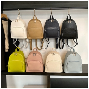 Detail view of mini backpacks in 8 assorted colors with textured litchi leather finish