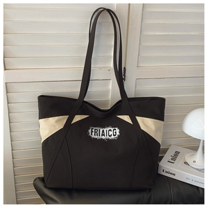Close-up of the contrasting color canvas tote bag featuring durable handles and FRIAICG logo