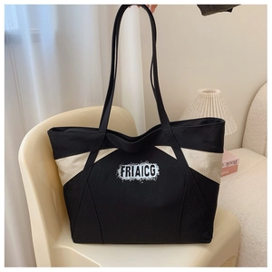 Detail of a large canvas tote bag with contrast stitching and FRIAICG logo text