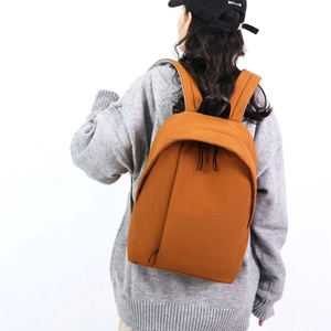Minimalist caramel brown backpack for men featuring adjustable straps and spacious main compartment