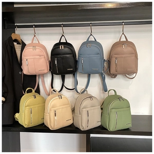 Multiple colorful mini backpacks in pebble grain PU leather on display shelves