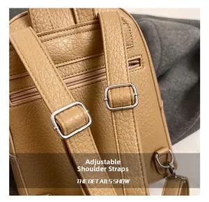 Detail view of adjustable straps and silver metal buckles on brown leather backpack