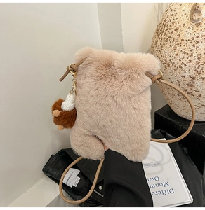 Detail of plush crossbody phone bag with brown strap and cute bear charm pendant