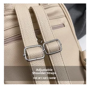 Detail of adjustable shoulder straps on cream pebbled leather backpack with silver buckle