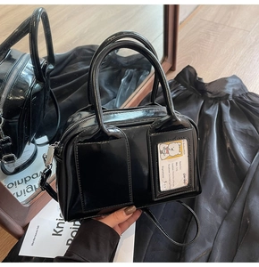 Detail of glossy black bowling bag featuring a creative ID card slot and twin handles