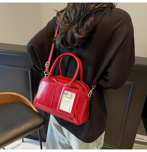 Close-up of red patent leather bowling bag with creative cartoon card slot detail
