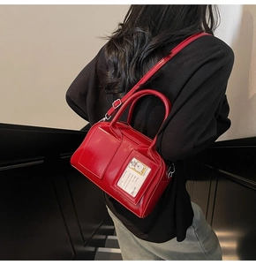 Close-up of red patent leather bowling bag with cute cartoon bear card slot detail
