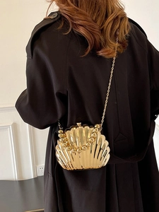 Elegant gold shell-shaped clutch bag with beaded handle and metal chain strap for women