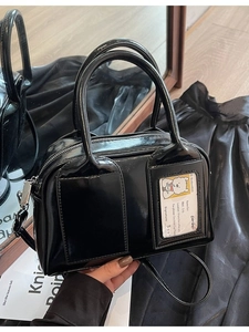Glossy black bowling bag with dual front pockets and transparent card slot detail