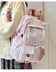 Detail showing calligraphy print and multi-pocket layout on high-capacity student backpack