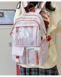 Detail of pink canvas backpack featuring red calligraphy prints and transparent pocket