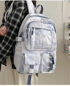 Side view of white landscape print backpack featuring multiple pockets and buckle detail