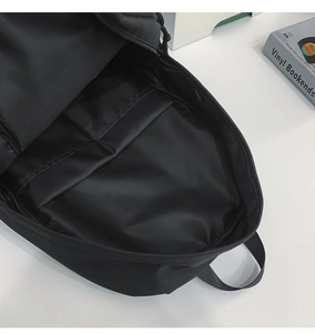 Interior view of black nylon backpack featuring a spacious main compartment and laptop sleeve