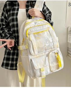 Detail of white and yellow canvas backpack with calligraphy art and clear pockets