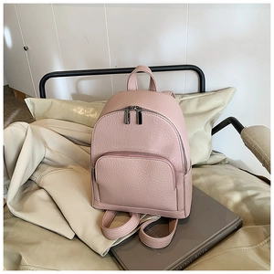 Close-up of pink lychee textured leather mini backpack with dual zipper detail