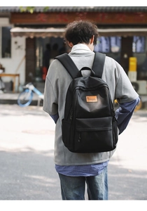 Detail of minimalist black backpack with TENGRUN logo on durable matte fabric