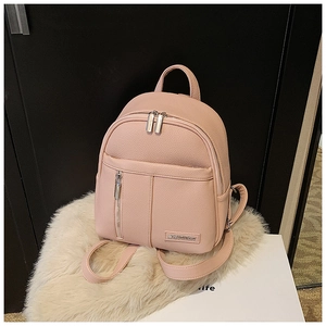 Detailed macro of the pink lychee textured mini backpack with silver zipper accents