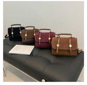 Detail view of four vintage crossbody bags in black brown burgundy and caramel leather