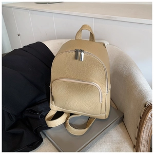 Detail of light brown pebble leather mini backpack with silver-tone hardware and zippers