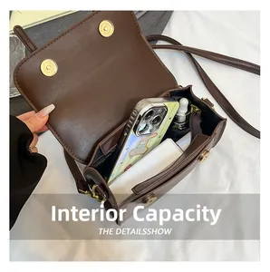 Internal capacity of dark brown leather crossbody bag with daily essentials and magnetic buckles