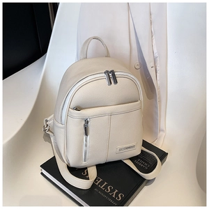 Detail of cream mini backpack with pebbled texture and silver metal brand logo