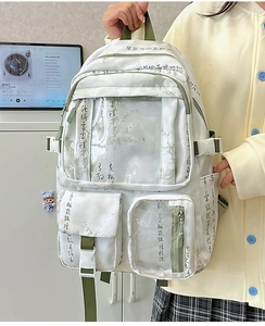 Detail of white canvas backpack featuring black calligraphy print and transparent PVC pockets
