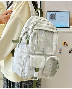 Detail of Chinese ink painting and calligraphy pattern on a white backpack with green straps
