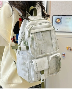 Detail of white canvas backpack with Chinese ink landscape painting and green straps