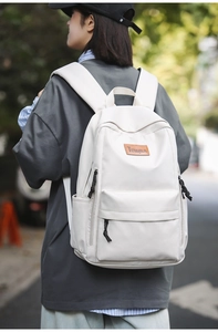 Detailed side view of off-white laptop backpack featuring premium leather brand logo