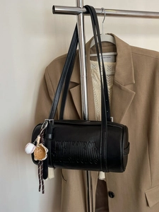 Vintage black cylinder shoulder bag with embossed letters and baseball charm