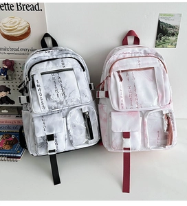 Detail of high-capacity student backpack featuring artistic Chinese calligraphy and multi-pockets