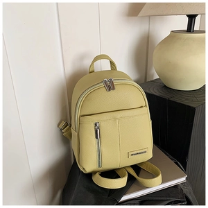 Close-up of lime green pebbled leather mini backpack with stylish vertical zip pocket